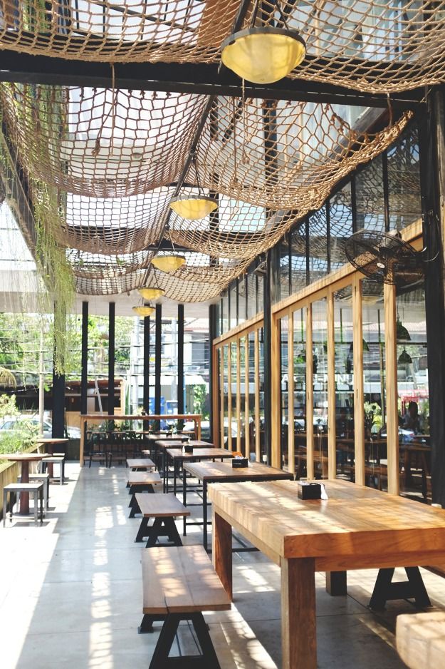 Inviting Cafe Design Blends Natural Light, Rustic Charm, and Communal Atmosphere