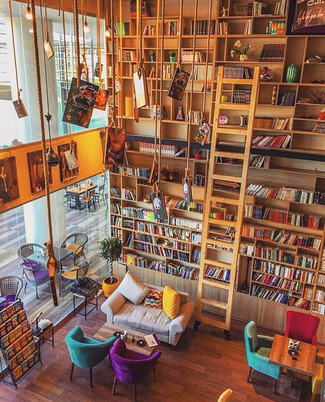 Cozy Cafe with Striking Vertical Bookshelf and Inviting Atmosphere