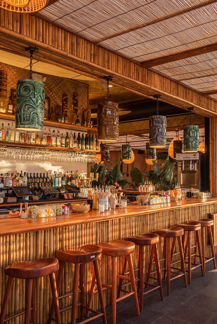 Tropical-Inspired Cafe Design: Warm Atmosphere with Bamboo, Tiki Lighting, Curated Beverages, and Natural Greenery