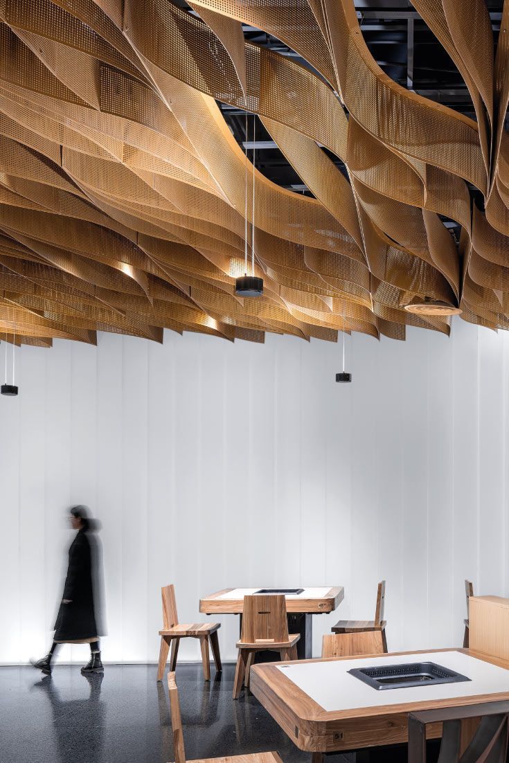 Modern Cafe Design Featuring Undulating Wooden Ceiling and Inviting Atmosphere