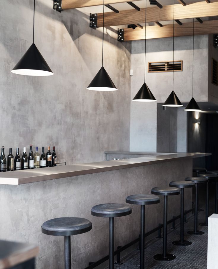 Sophisticated Minimalist Cafe Design Featuring Concrete Walls and Elegant Seating