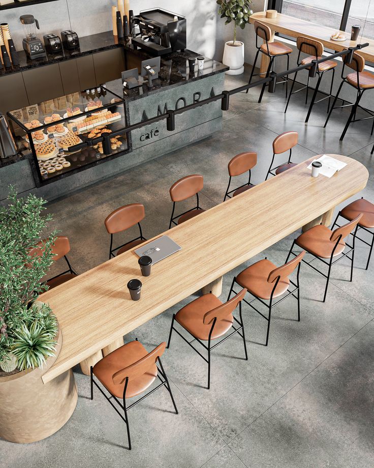 Modern Cafe Design: Spacious Layout with Communal Table, Stylish Seating, and Inviting Aesthetic