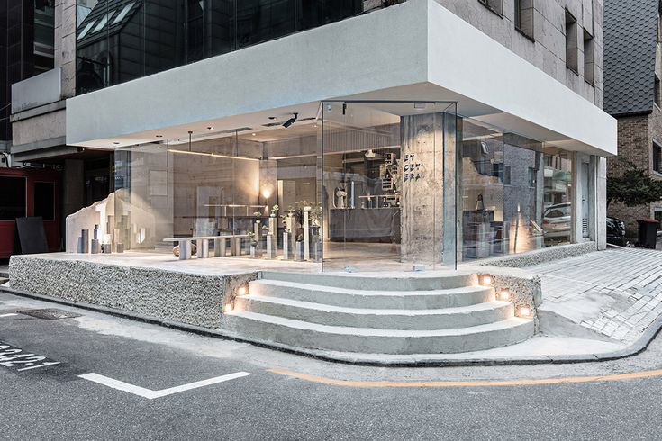 Modern Minimalist Cafe Design with Seamless Urban Integration and Inviting Atmosphere