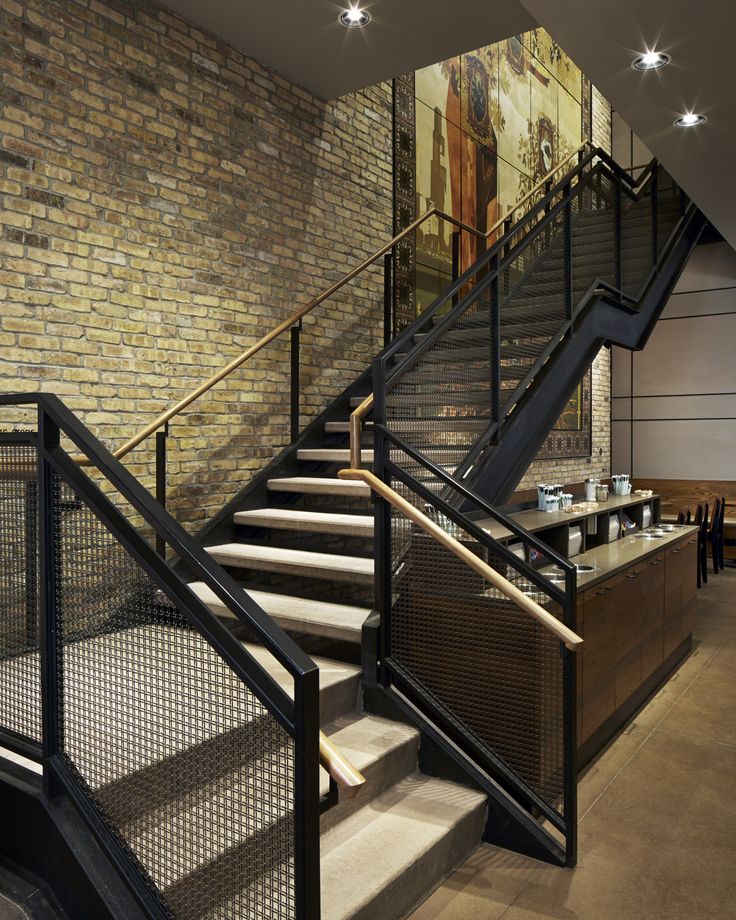 Stylish Cafe Design with Dramatic Staircase and Inviting Atmosphere