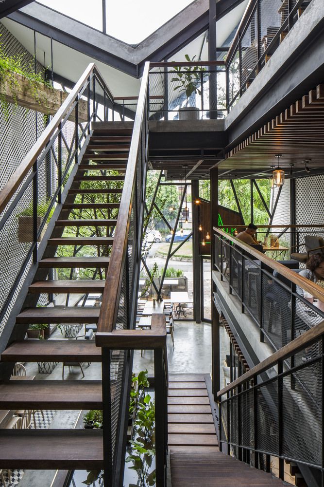 Contemporary Industrial Cafe Design: Spacious Multi-Level Layout with Natural Light, Greenery, and a Community-Oriented Atmosphere