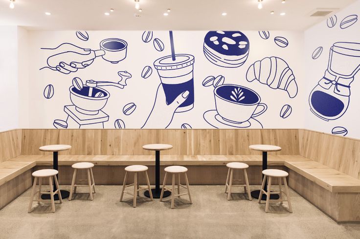 Minimalist Cafe Design with Soothing Woods, Whites, and Playful Mural