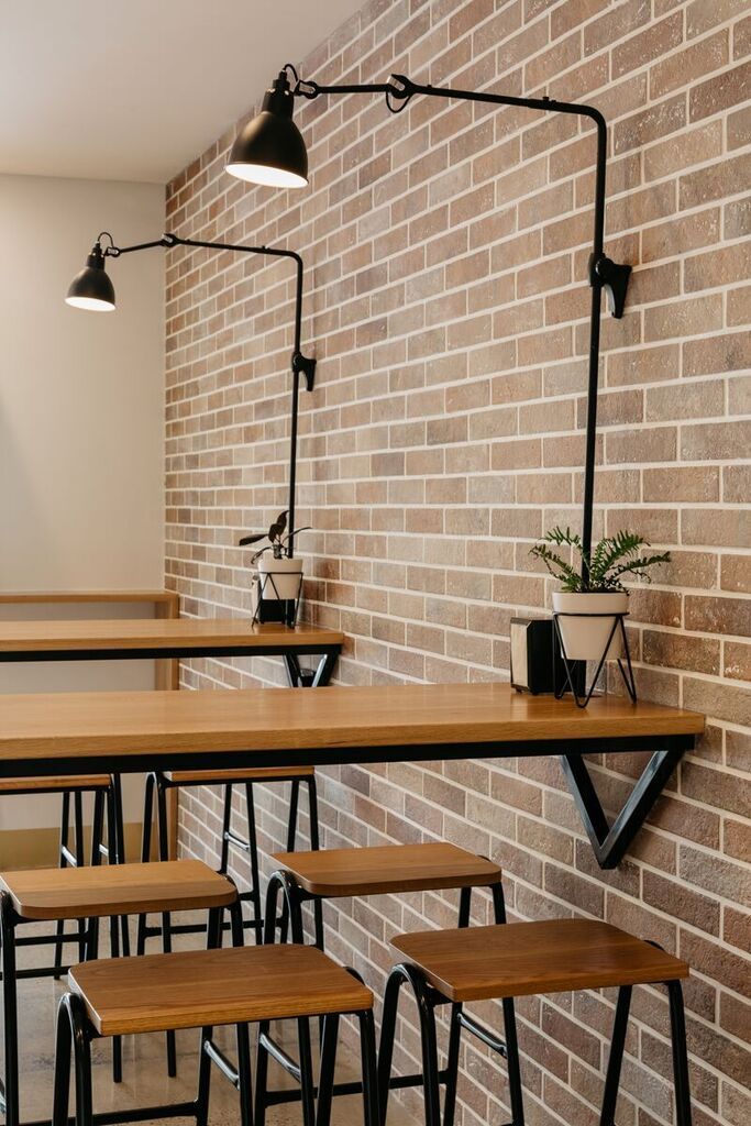 Modern Cozy Cafe Design: Inviting Atmosphere with Warm Colors and Communal Dining