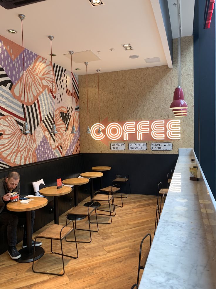 Cozy Contemporary Cafe: A Vibrant Blend of Bold Patterns, Warm Wood, and Modern Aesthetics