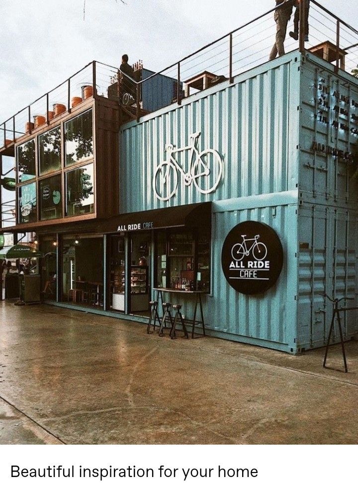 Modern Cafe Design: Repurposed Shipping Containers with Industrial Aesthetics and Bicycle Motif