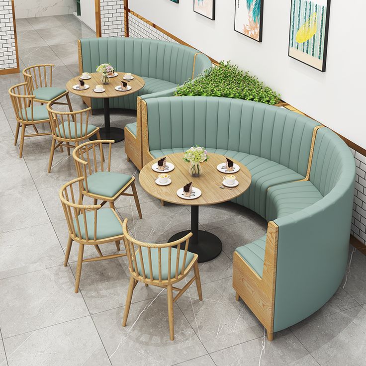 Contemporary Cafe Design Blends Curved Seating, Wooden Accents, and Greenery for an Inviting Atmosphere