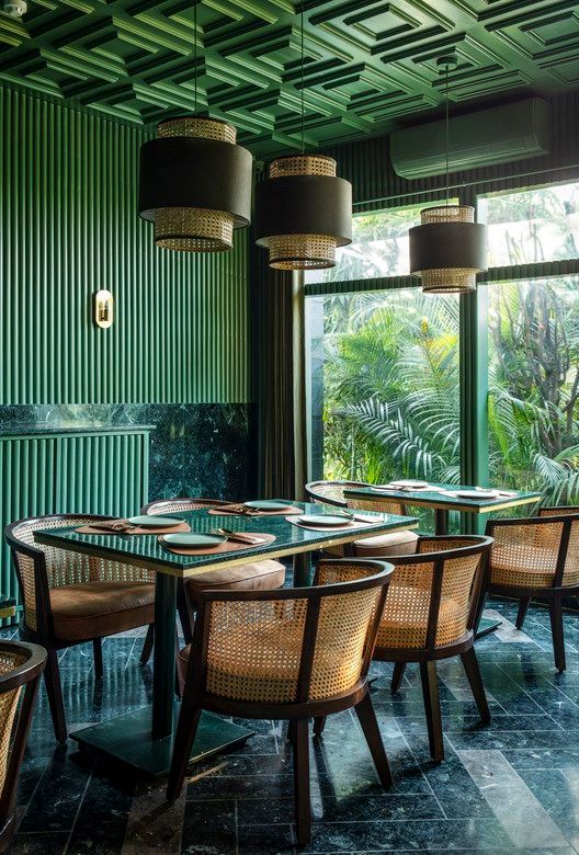 Inviting Cafe Design Blends Striking Green Palette with Sophisticated Accents