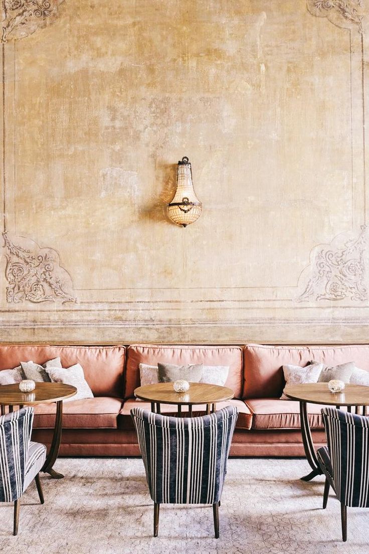 Chic Cafe Design: Warm Ambiance with Textured Walls, Plush Seating, and Vintage Lighting