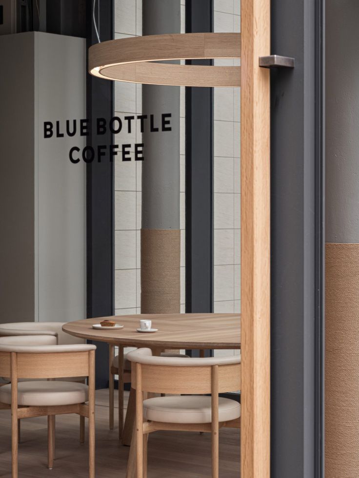 Modern and Inviting Cafe Design Enhances Community Atmosphere with Natural Light and Warm Elements