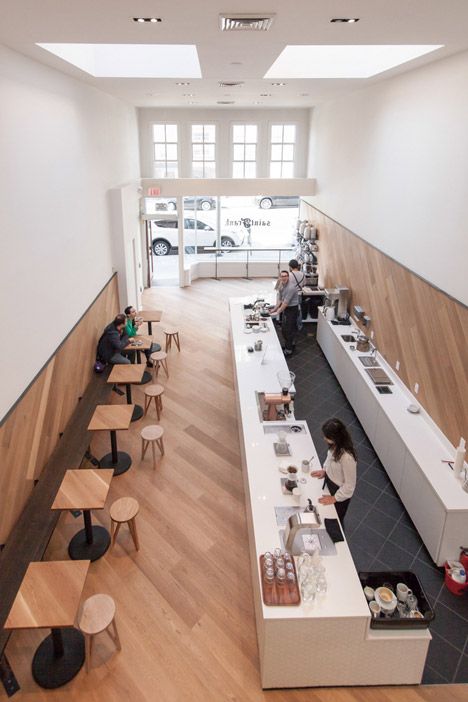 Modern Cafe Design: A Warm, Inviting Space with Minimalist Aesthetics and Ample Natural Light