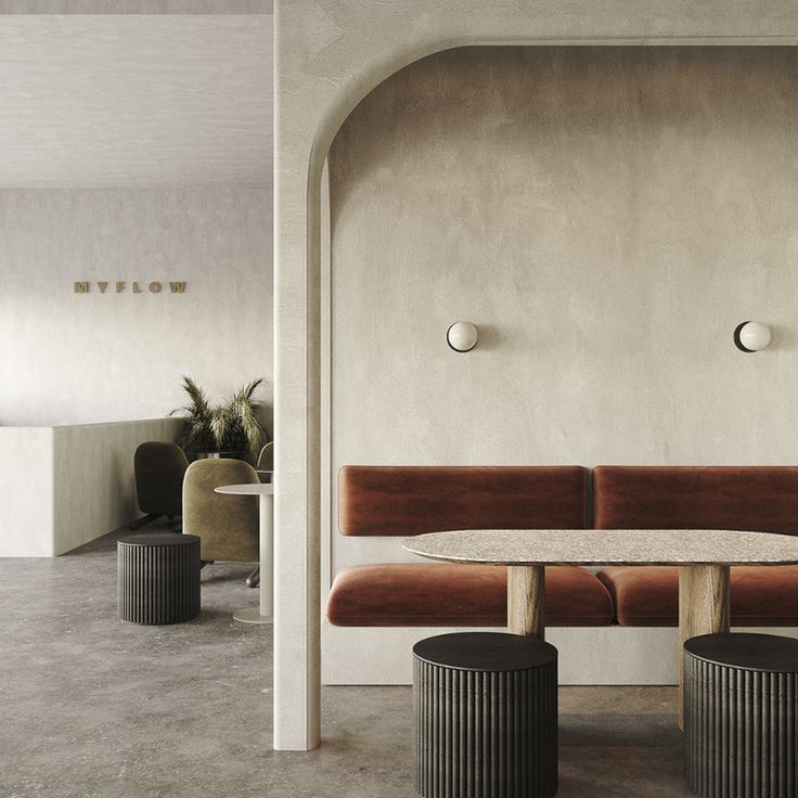 Modern Minimalistic Cafe Design: Serene Atmosphere with Curved Arches, Plush Seating, and Natural Light