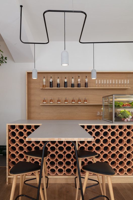 Modern Minimalist Cafe Design with Striking Wooden Bar and Inviting Atmosphere