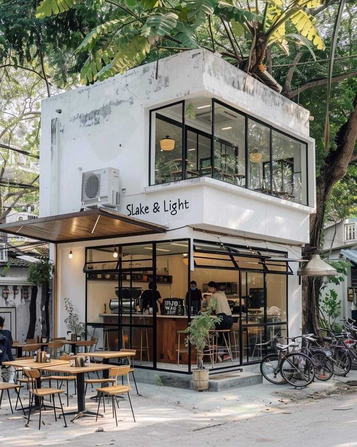 Contemporary Cafe with Minimalist Design and Inviting Terrace Amidst Greenery