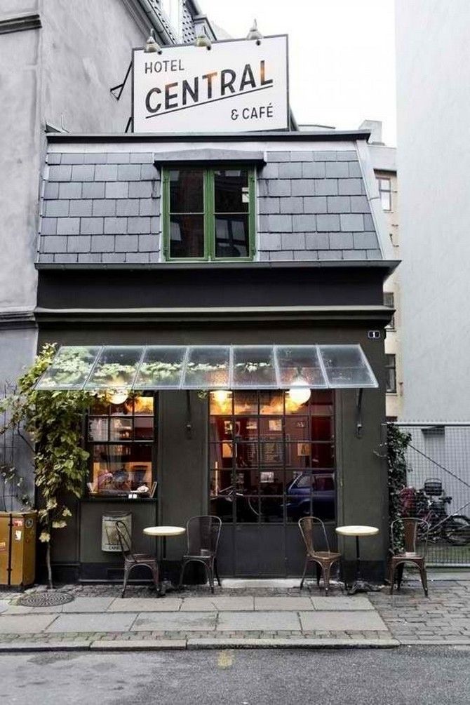 Charming Cafe Design: Inviting Slate Roof, Vibrant Green Accents, and Cozy Outdoor Seating