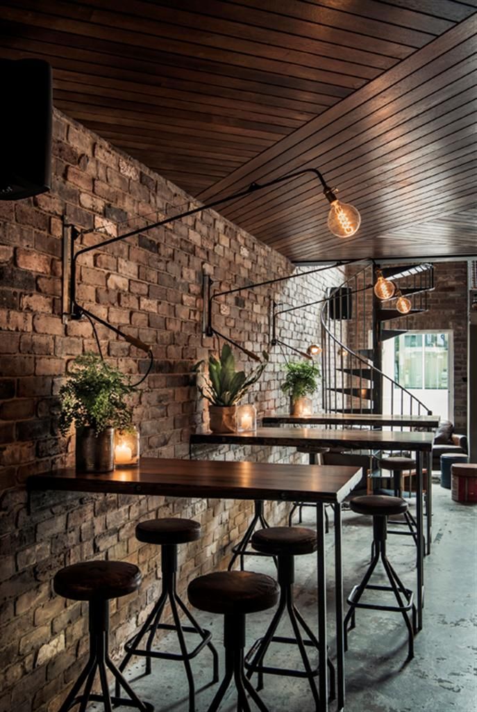 Cozy Industrial Cafe Design with Exposed Brick, Warm Accents, and Inviting Ambiance