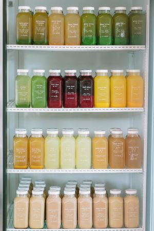 Modern Refrigerator Showcases Vibrant Assortment of Bottled Beverages in Contemporary Cafe Design