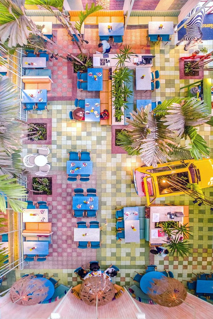 Vibrant Cafe Design Merges Colorful Seating, Playful Tiles, and Whimsical Elements for a Welcoming Atmosphere