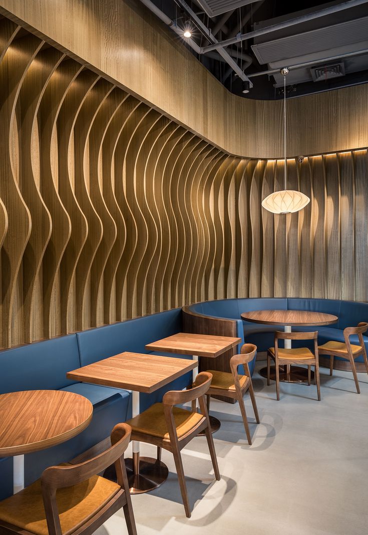 Modern Cafe Design: Inviting Aesthetic with Wavy Wood Accent Wall and Cozy Ambiance