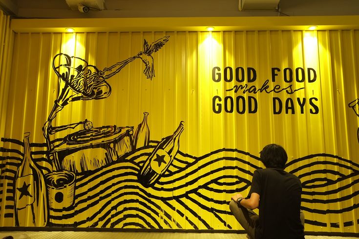 Cheerful Cafe Interior with Vibrant Yellow Walls and Playful Illustrations Inviting Relaxation