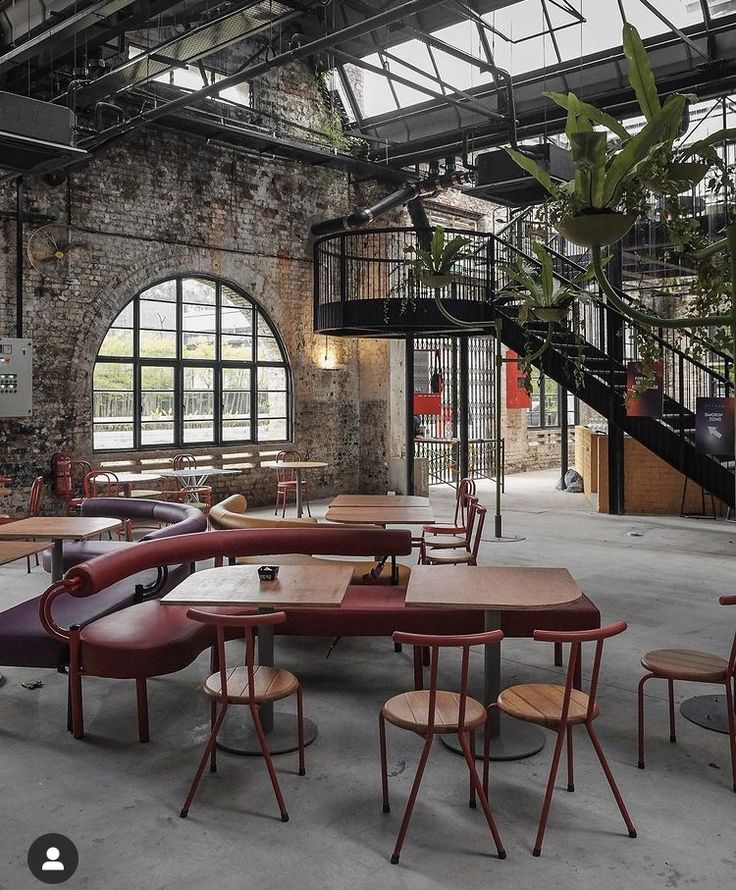 Stylish Industrial-Chic Cafe Design with Expansive Layout and Greenery