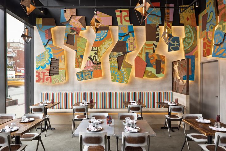 Vibrant Cafe Design with Striking Mural and Communal Atmosphere