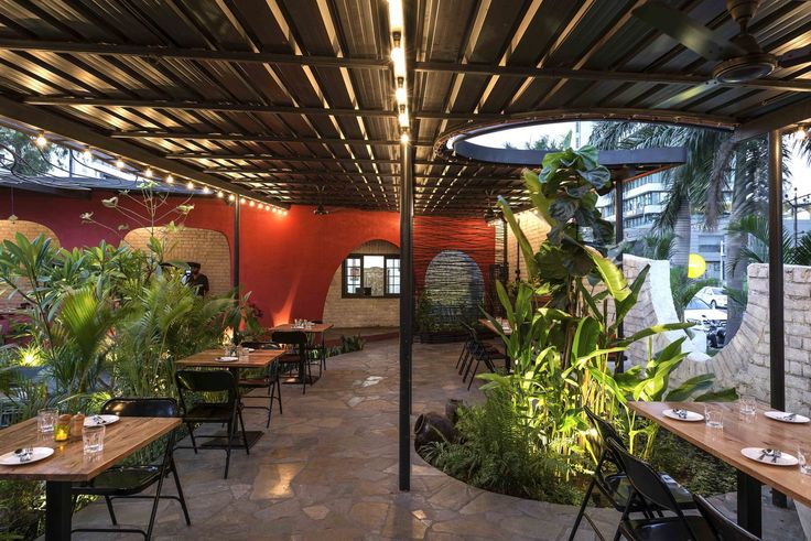 Inviting Cafe Design: A Harmonious Blend of Modern and Rustic Elements with Lush Greenery and Warm Tones