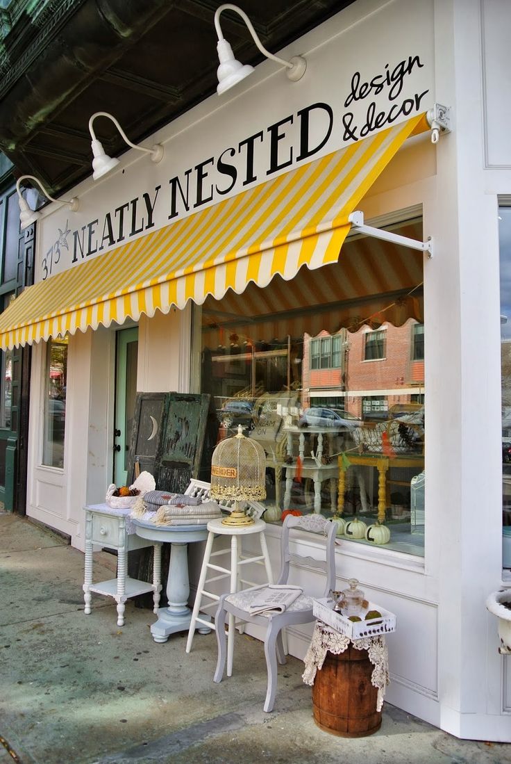 Charming Cafe Exterior with Cheerful Awning and Inviting Design Elements