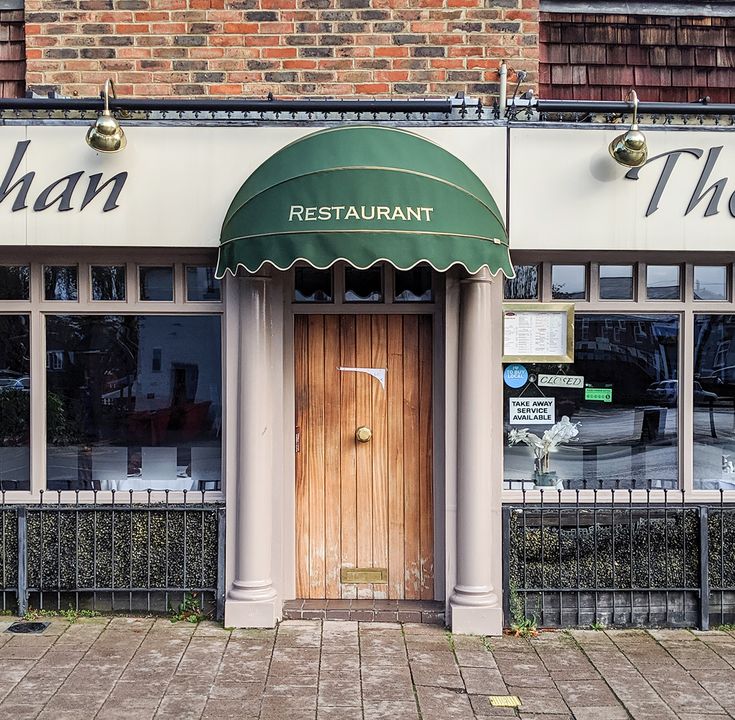 Charming Cafe Entrance: Elegant Design with Inviting Atmosphere