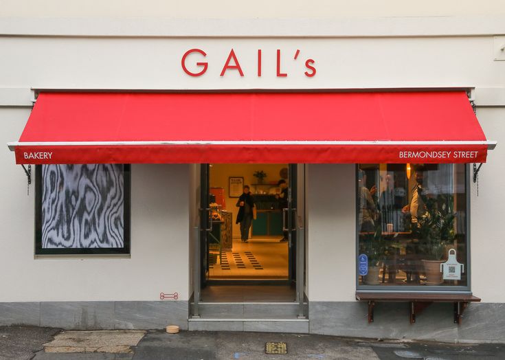 Charming Cafe Design: Vibrant Red Awning and Inviting Atmosphere Create a Welcoming Experience