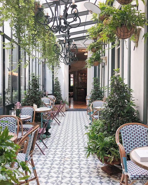 Charming Cafe Design Balancing Elegance and Relaxed Ambiance with Lush Greenery and Classic French Aesthetics