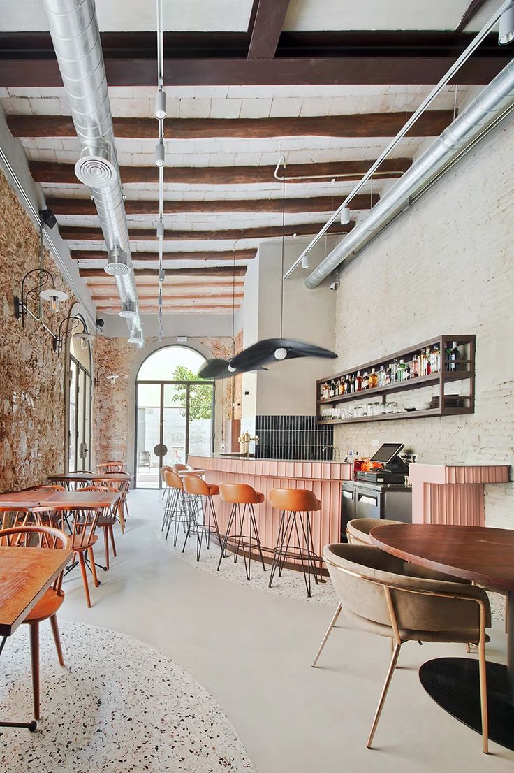 Inviting Cafe Design: A Rustic-Modern Blend with Exposed Brick, Sleek Bar Area, and Warm-toned Seating