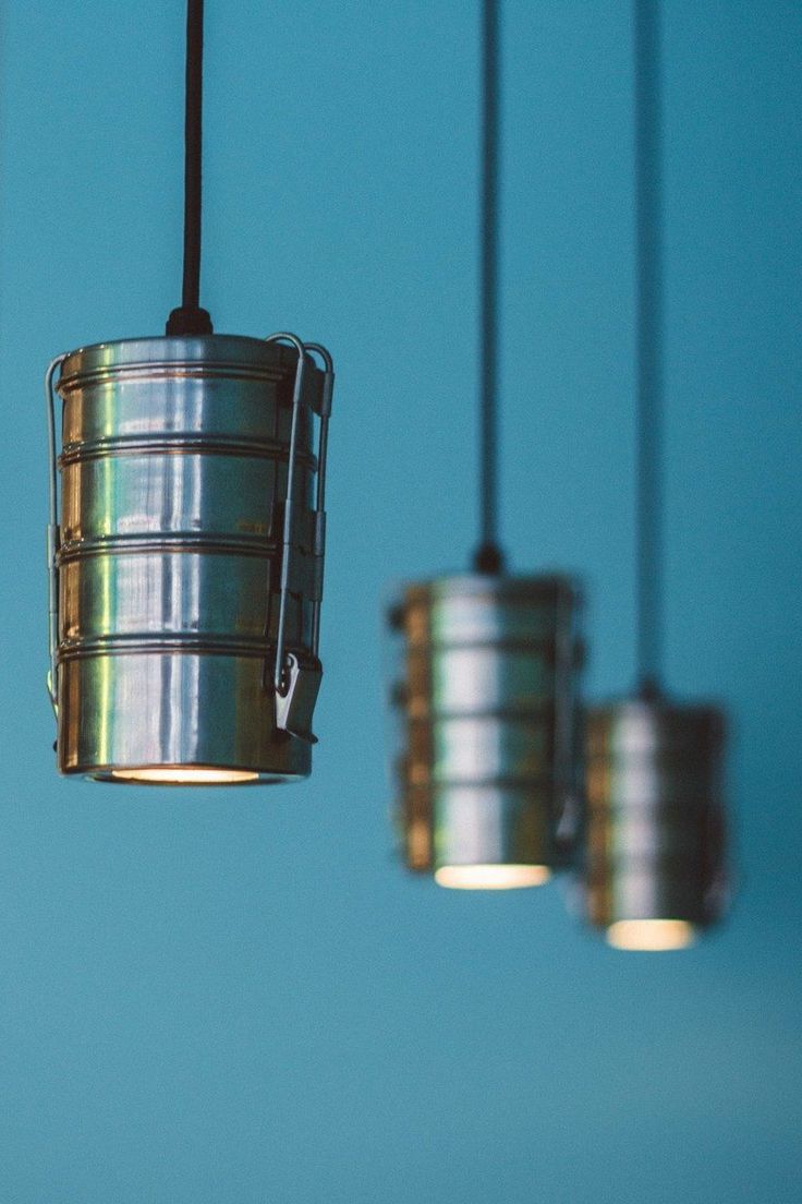 Modern Cafe Design with Vibrant Teal Aesthetic and Innovative Pendant Lighting