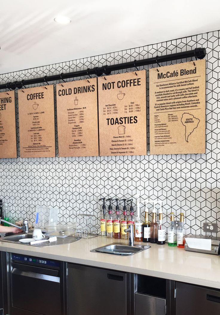 Modern Minimalist Cafe Design Featuring Striking Hexagonal Tile and Rustic Menu Boards