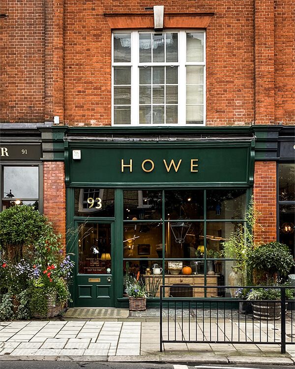 Charming Cafe Showcases Elegant Design with Green Awning and Inviting Decor