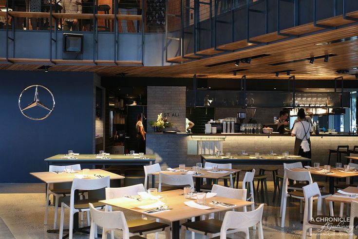 Modern Cafe Design: A Chic, Spacious Venue with Inviting Ambiance and Open Kitchen Views