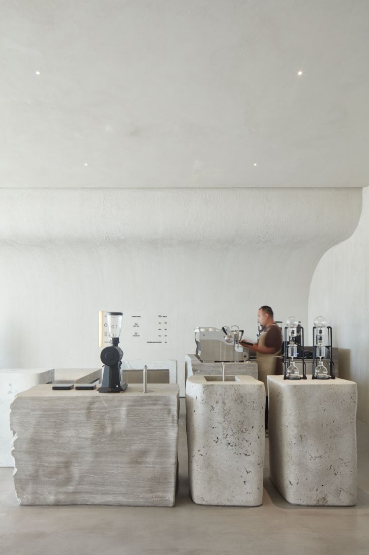 Minimalist Cafe Design with Sculptural Concrete and Inviting Atmosphere