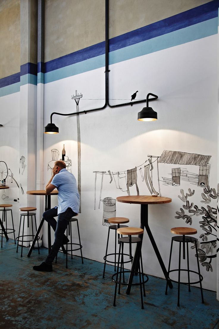 Modern Minimalist Cafe Design Blends Whimsical Art and Casual Atmosphere