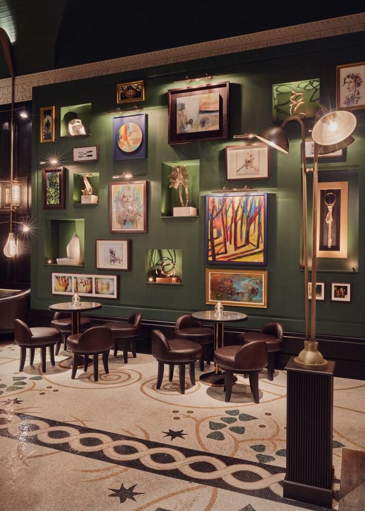 Inviting Cafe Design: Deep Green Walls, Eclectic Art, Elegant Tiles, and Cozy Lighting