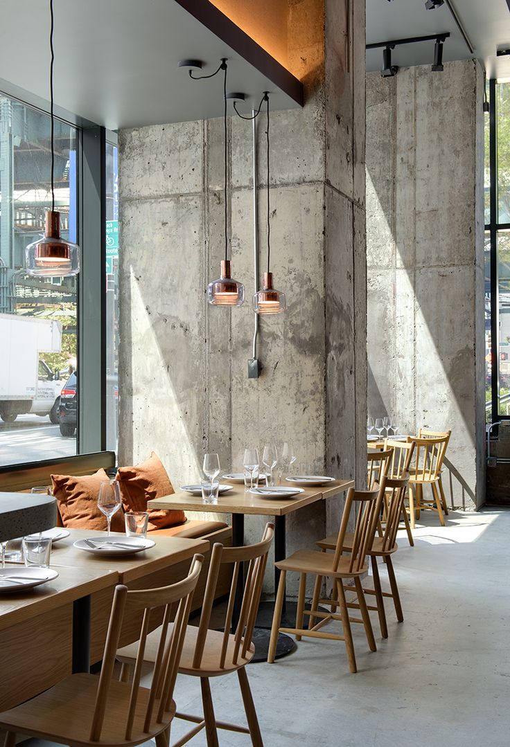 Modern Industrial Cafe: Inviting Atmosphere with Stylish Minimalism and Natural Light