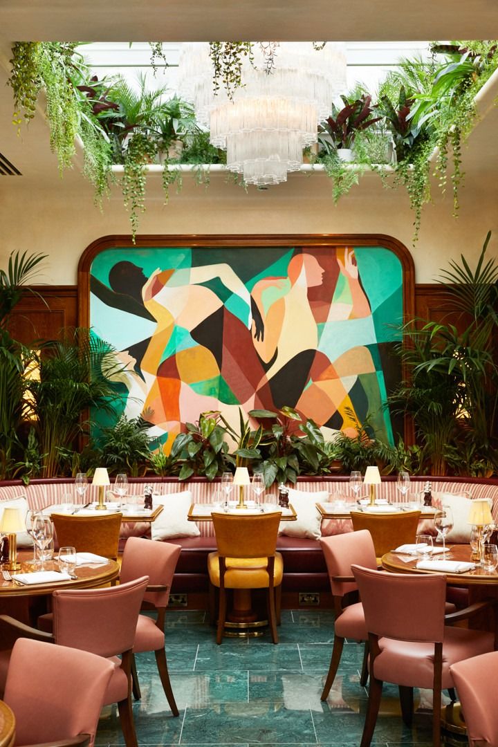 Vibrant Cafe Design: Bold Mural, Lush Greenery, and Elegant Atmosphere