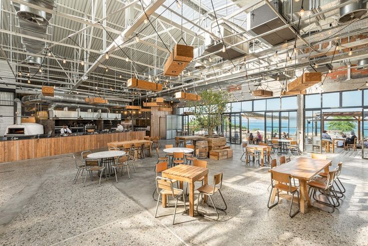 Spacious Cafe Design Blends Modern Industrial Aesthetics with Inviting Ambiance and Seamless Outdoor Connection