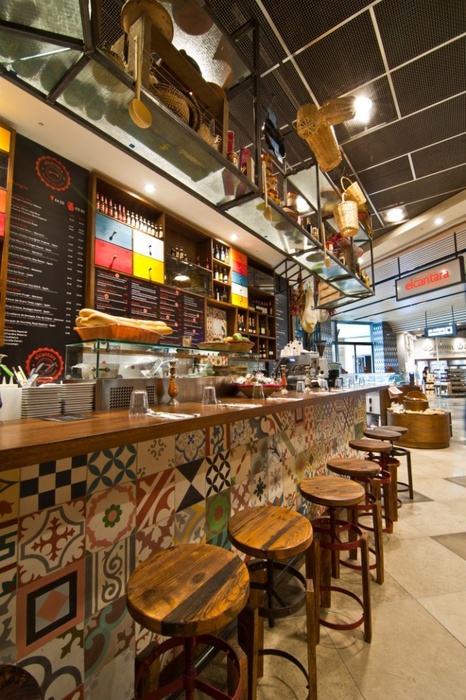 Vibrant Cafe Design with Mosaic Wall and Rustic Charm Creates Inviting Atmosphere