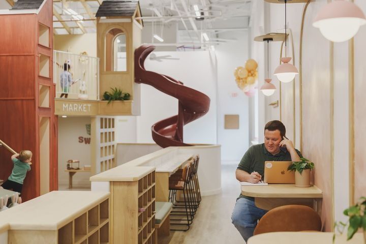 Inviting Cafe Design Blends Social Workspace with Family-Friendly Atmosphere