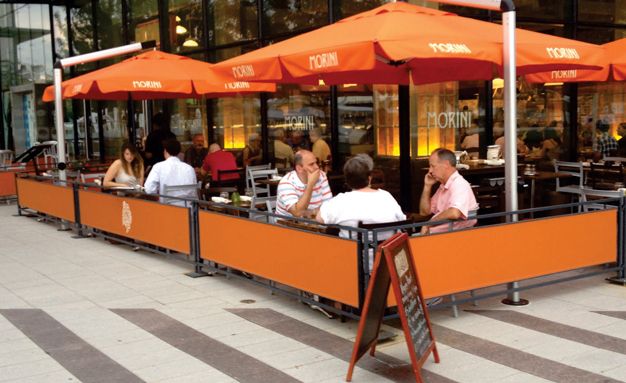 Inviting Urban Cafe Design with Bright Outdoor Seating and Contemporary Aesthetics