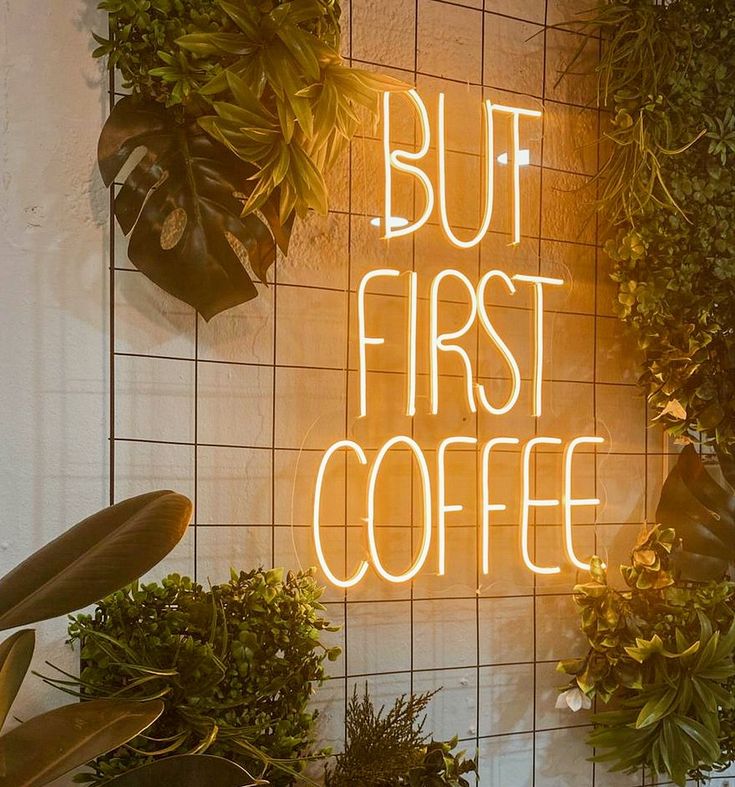 Charming Cafe Design Blends Neon Glow with Lush Greenery for a Cozy Atmosphere