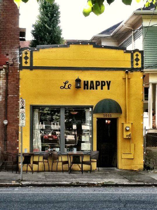 Charming Cafe with Vibrant Yellow Facade and Inviting Atmosphere